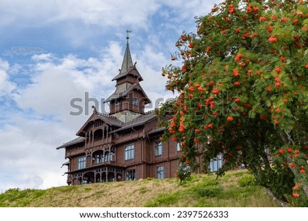 A picture of the Scandic Holmenkollen Park Hotel and a nearby flower tree.