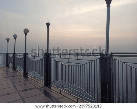 The Lamps on the handrail of the bridge with the backdrop of evening sunset. 