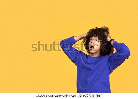 Shocked Black Young Man Opening Mouth And Touching Head While Looking At Copy Space, Surprised Millennial African American Guy Standing Isolated Over Yellow Studio Background, Reacting To Offer