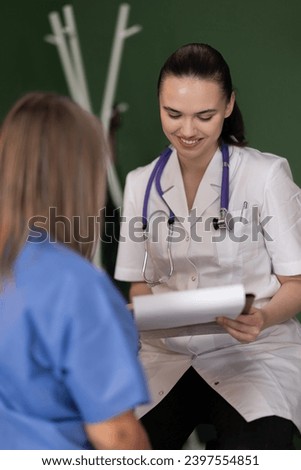 Young female doctor discusses results with senior patient in hospital.
