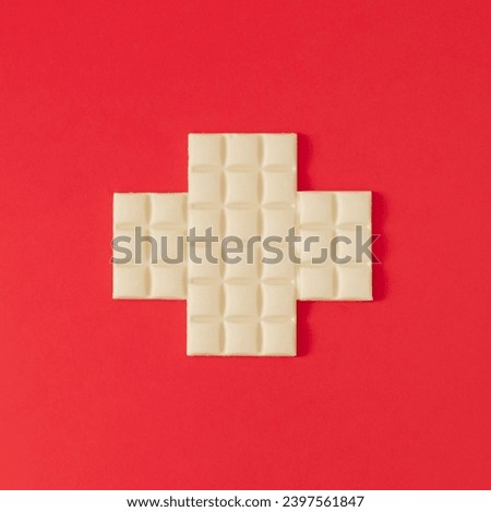 Flag of Switzerland made with white chocolate. Realistic aesthetic look. Minimal concept. Trendy Swiss flag and white chocolate idea. Yummy chocolate bars composition. Unique flat lay background.