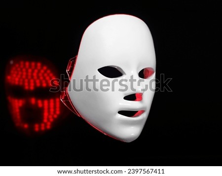 Cosmetic LED mask. Concept of an android face and a virtual reality mask. Royalty-Free Stock Photo #2397567411