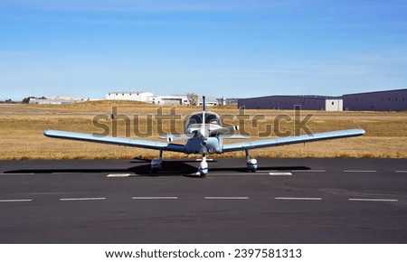 Front View of a Single Engine Propeller Plane Parked at an Airport Royalty-Free Stock Photo #2397581313
