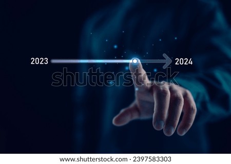 Businessman touch on virtual bar status to change from 2023 to 2024, countdown of merry Christmas and happy new year by technology concept, start new business and new life. New year's start-up. Royalty-Free Stock Photo #2397583303