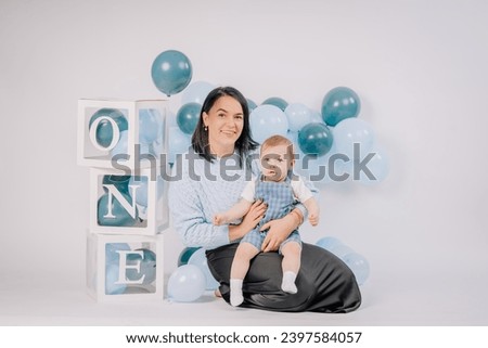 Mother with her son on the 1st anniversary in the studio