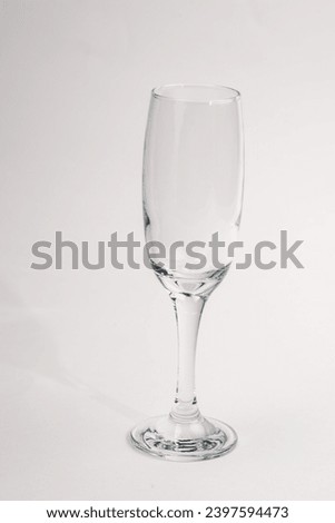 Empty champagne glass on white background Royalty-Free Stock Photo #2397594473
