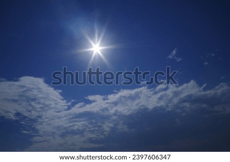 Vibrant sunburst with beautiful blue sky  and cloud patterns as back ground.