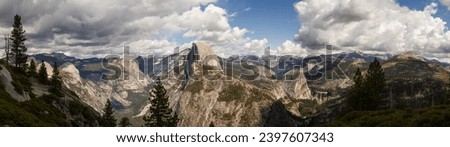 View of Sentinel Dome and Half of Dome in panorama landscape of rock hills with trees and blue sky with clouds at autumn sun in California, amerina and Usa Royalty-Free Stock Photo #2397607343