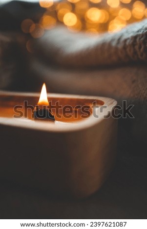 Candle in tree, stylish home interior, winter mood.