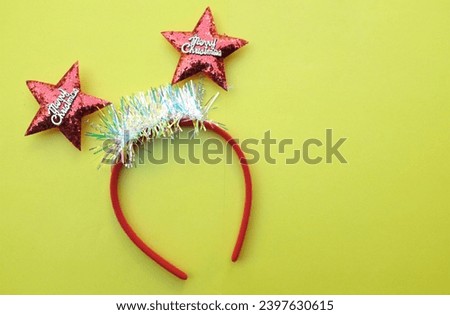 decorated Beautiful headband funny red star isolate on a yellow backdrop.
concept of joyful Christmas party,New year is coming soon, festive season decoration with Christmas elements