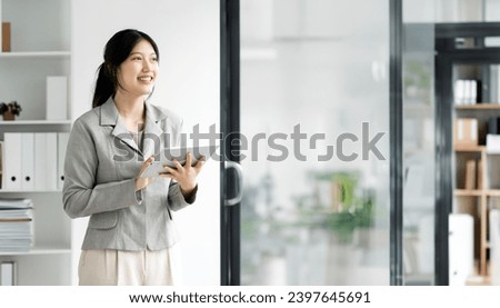Successful business woman using a tablet computer at the office