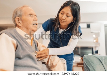 Home nurse auscultating the heartbeats of an elderly man with a stethoscope Royalty-Free Stock Photo #2397646227
