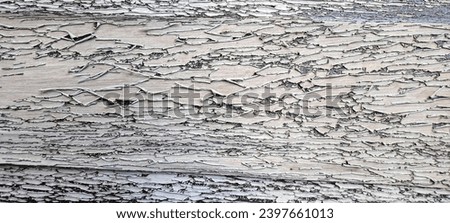 Cracked peeled gray paint on a wooden surface. Textured surface. Old wooden background