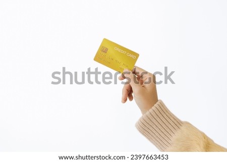 Woman's right hand holds a golden credit card, isolated on a white background. Concept of technology, connection, communication, social, online shopping.