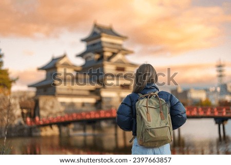 Woman tourist Visiting in Matsumoto, happy Traveler sightseeing Matsumoto Castle or Crow castle. Landmark and popular for tourists attraction in Matsumoto, Nagano, Japan. Travel and Vacation concept Royalty-Free Stock Photo #2397663857