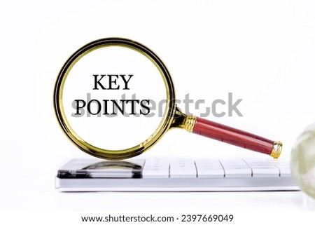 KEY POINTS lettering through a magnifying glass on a calculator and part of a magic ball in the foreground without focus