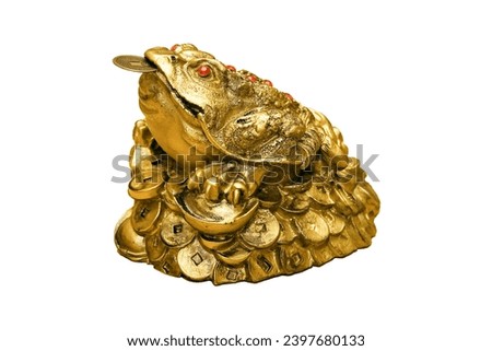 The money frog, a feng shui symbol for prosperity, and coins are all isolated on a white background. Royalty-Free Stock Photo #2397680133