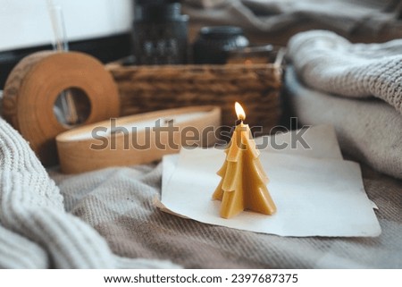 Beeswax Christmas tree candle, cozy photo.