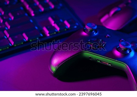 Computer keyboard, mouse and joystick on black background