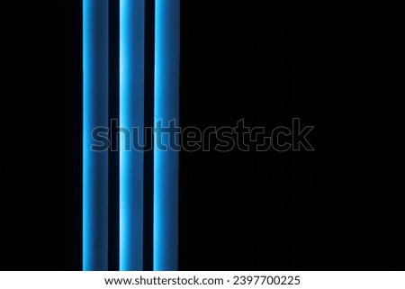 three lines of blue light on a black background