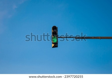 Traffic light showing red with blue sky background