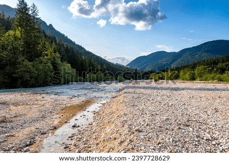 Beautiful mountain stream river bed, passing its way through the mountain terrain and forest area of slovenian Alps, under the Triglav mountain Royalty-Free Stock Photo #2397728629