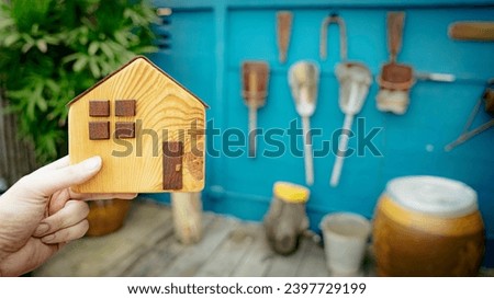 House model in home insurance broker agent ‘s hand or in salesman person. Real estate agent offer house, property insurance and security, affordable housing concepts	