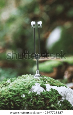 Sound Therapy Fork Instrument Vibrating and Radiating Sound into the Environment Royalty-Free Stock Photo #2397735587