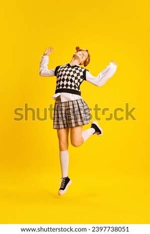 Full-length portrait of overjoyed young lady dressed retro fashion outfit highly jumping because she happy against yellow background. Concept of human, emotions, youth, studying, sales season, hobby.