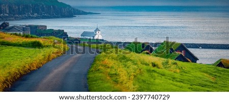 Panoramic summer view of Kirkjubour village with turf-top houses, Faroe Islands,  Denmark, Europe. Wonderful morning scene of Hestur Island. Traveling concept background. Royalty-Free Stock Photo #2397740729