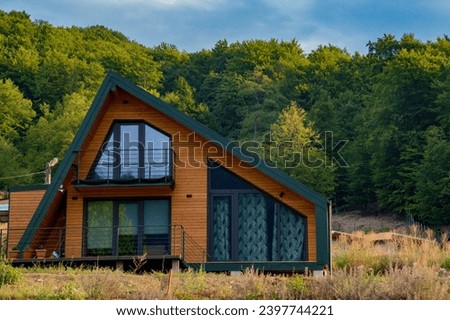 Small modern modular house in the forest. Royalty-Free Stock Photo #2397744221