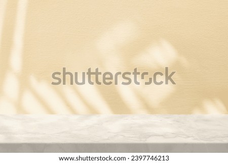 White Marble Table with Palm Leaves Shadow on Beige Wall Texture Background, Suitable for Product Presentation Backdrop, Display, and Mock up.
