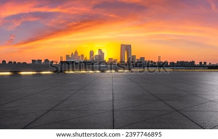 City square and skyline with modern buildings at sunset in Suzhou, Jiangsu Province, China. Panoramic view.