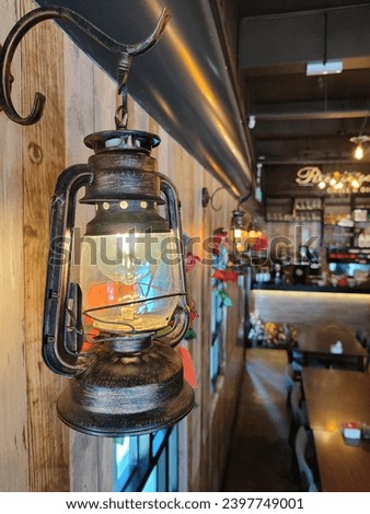 the atmosphere of a western restaurant with lantern lights, wooden walls brings it like being in a cowboy shop