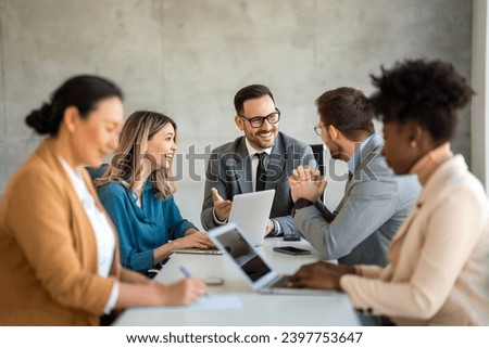 Successful business professionals presenting analytical report, working together in corporate office Royalty-Free Stock Photo #2397753647