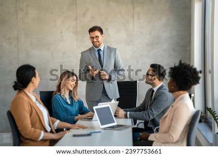 Successful multiethnic business people presenting analytical report while working together in office Royalty-Free Stock Photo #2397753661