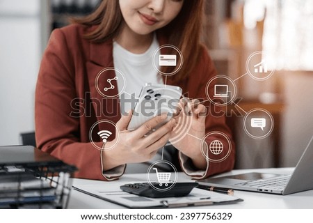 Social media icons screen of businessman with smartphone and laptop computer at office at morning light.