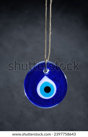 Big evil eye bead on black background