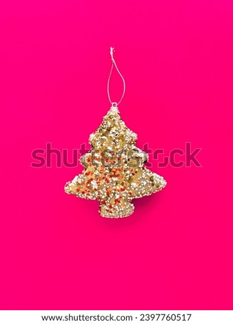 Beautiful Christmas decorations, shiny Christmas tree toy on a bright pink background. Christmas poster design. New Year Poster