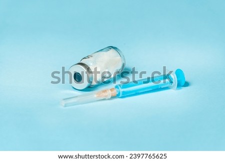 Syringe and needle with glass medical ampoule vials for injection. Medicine is dry white drug penicillin powder or liquid with of aqueous solution in ampulla Royalty-Free Stock Photo #2397765625