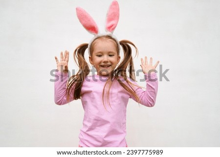 A funny laughing child in the guise of a rabbit on white bacground. The year according to the zodiac sign of the Eastern calendar. Easter Greeting poster