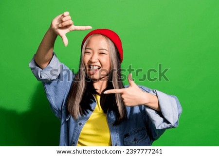 Photo of pretty tricky lady wear denim jacket showing stick out arms photo gesture empty space isolated green color background