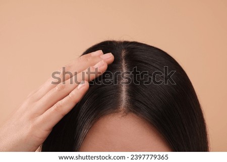 Woman with healthy hair on beige background, closeup Royalty-Free Stock Photo #2397779365