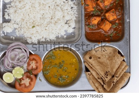 Veg Thali with chapati, roti, poli, bhat, rice, panner, paneer bahji, bhaji, salad, curry and salad Royalty-Free Stock Photo #2397785825