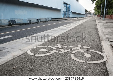 View of bicycle icon symbol on bicycle lane on the road of downtown in Bangkok, Thailand. Cycling friendly city in Thailand. 