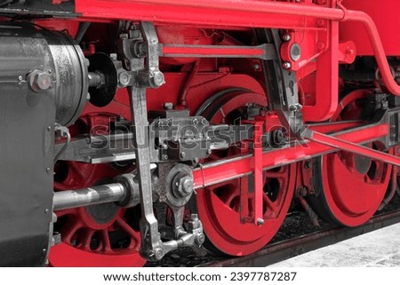 Close-up of red wheels of an old steam train locomotive Royalty-Free Stock Photo #2397787287