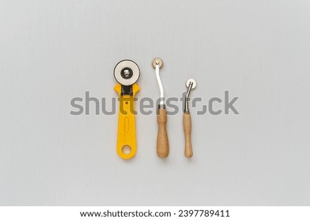 Tailoring sewing tools, tracing wheel, needle point tracing wheel with wood handles Royalty-Free Stock Photo #2397789411