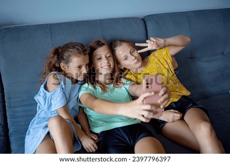 kids taking selfie at home on the sofa