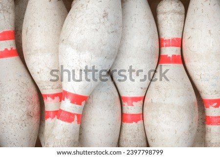 Vintage weathered white bowling pins with red stripe