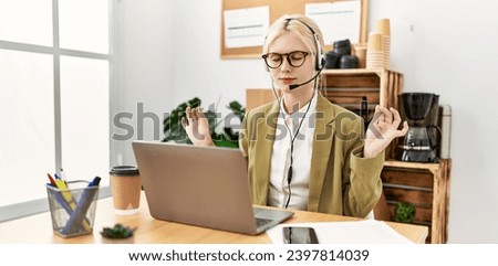 Young blonde woman business worker doing yoga exercise at office